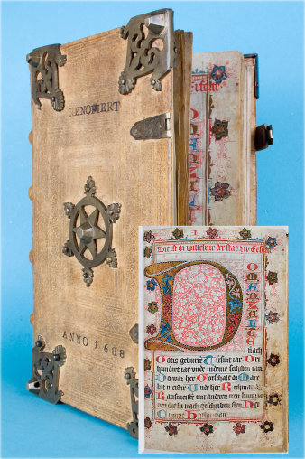 In Pergament gebundenes, mit Beschlägen versehenes Buch, Anno 1688. Auf dem Buchdeckel das angedeutete Erfurter Rad. Im Vordergrund rechts die Abbildung einer farbig gestalteten Seite mit der Initiale "D".
