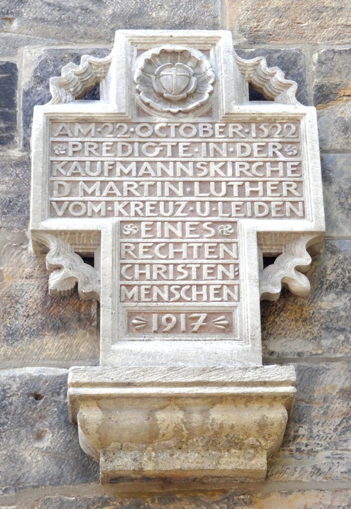 Gedenkstein an der Erfurter Kaufmannskirche Ein Kreuz in Stein gehauen, darauf ein Schriftzug mit Jahreszahl 1917. Oben ist die Lutherrose abgebildet.