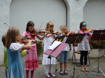 Kinder musizieren auf Geigen