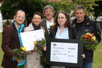 Das Foto zeigt die stolzen 5 Preisträger für das Projekt InnoNet unter Federführung von Prof Thumfart. Sie Präsentieren Urkunde, symbolischen Scheck und Blumen.