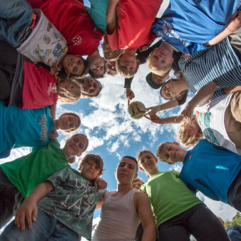 Foto: Keine Langeweile in den Ferien mit dem Team Spirit of Football © Stadtverwaltung Erfurt/Grit Kästner Sechzehn Kinder stehen im Kreis und halten einen Fußball in die Höhe.