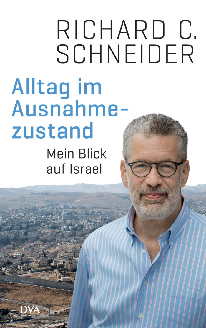 Buchcover: Alltag im Ausnahmezustand. Mein Blick auf Israel von Richard C. Schneider Mann mit einem blauen Hemd und großer runder Brille vor einer Hügellandschaft mit Häusern, darüber Buchtitel