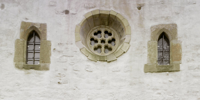 Ausschnitt Fassade Alte Synagoge Fassadenausschnitt. Ein großes, rundes Rosettenfenster wird von zwei kleineren Lanzetfenstern flankiert