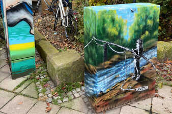 Graffiti-Projekt Medienkästen gestaltet mit Naturmotiven, ein Kind angelt am Fluss.