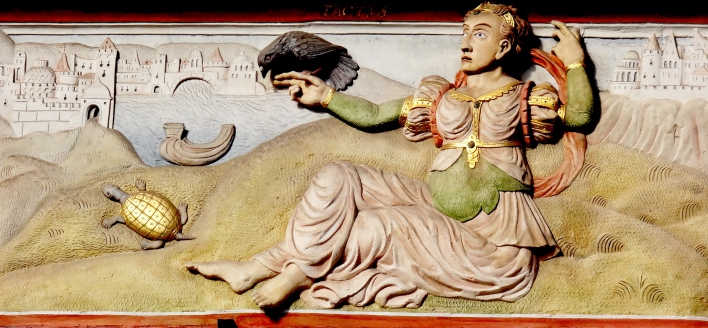 Allegorie einer sitzenden Frau mit ausgestrecktem Arm, auf dem ein Vogel sitzt. Im Hintergrund fiktive Stadt mit Fluss.