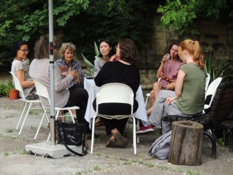 Eine Gruppe von Menschen sitzt im Kreis.