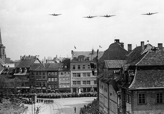 ein SW Foto mit Jagdflugzeugen in Formation über dem Domplatz