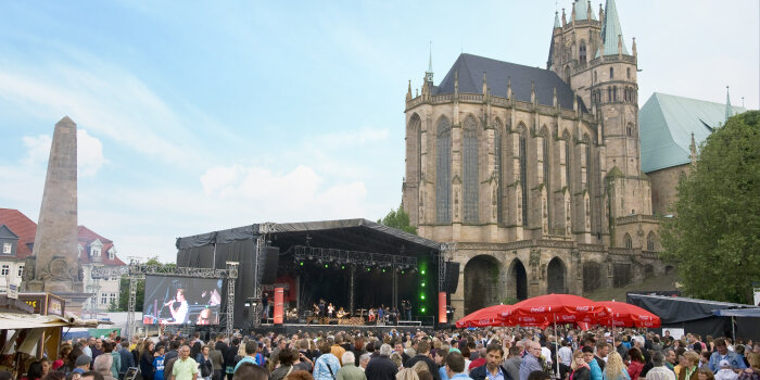 Publikum, große Bühne und im Hintergrund der Dom St. Marien