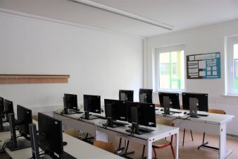 Das Foto zeigt einen möblierten Klassenraum mit vielen Computern.