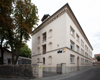 VHS-Gebäude: Eingang Helles, mehrstöckiges Gebäude mit VHS-Logo