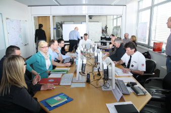 Das Foto zeigt den Führungsstab der Feuerwehr erfurt bei der Arbeit im Stabsraum. Mehrere mitarbeiter erledigen konzentriert Einzelaufgaben zur Abarbeitung eines Schadensereignisses größeren Umfangs. 