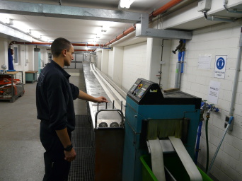 Feuerwehrmann bei der Arbeit an der Schlauchwaschanlage