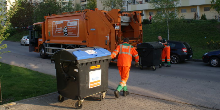 Müllauto und Müllmänner in Aktion