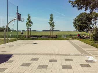 gepflasterter Platz mit Basketballkorb