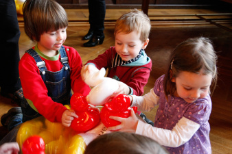 Kinder tragen einen Sack voller Plastikenten.