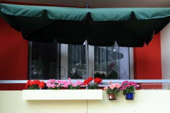Balkon mit bunten Blumen im Balkonkasten.