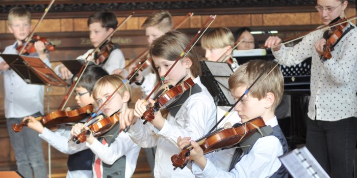 Foto: Musikschulkinder beim Konzert © Stadtverwaltung Erfurt Kinder spielen mit Streichinstrumenten in einem historischen Saal.