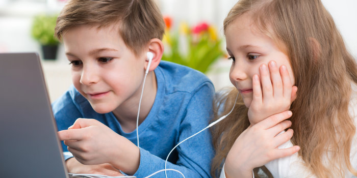 zwei Kinder schauen auf den Computer