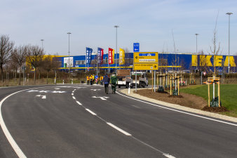 Eine Straßenkreuzung mit einem Baufahrzeug und mehreren Personen