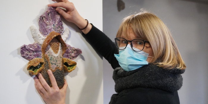Foto: Landesstipendiatin Kristin Wenzel © Stadtverwaltung Erfurt eine Frau hängt ein Kunstwerk an die Wand
