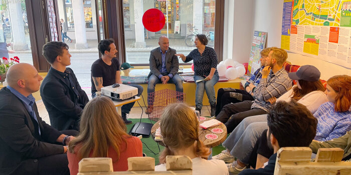 Foto: Diskussionsrunde zur Willkommenswoche für Studierende © Stadtverwaltung Erfurt elf Menschen sitzen in einer Runde und diskutieren
