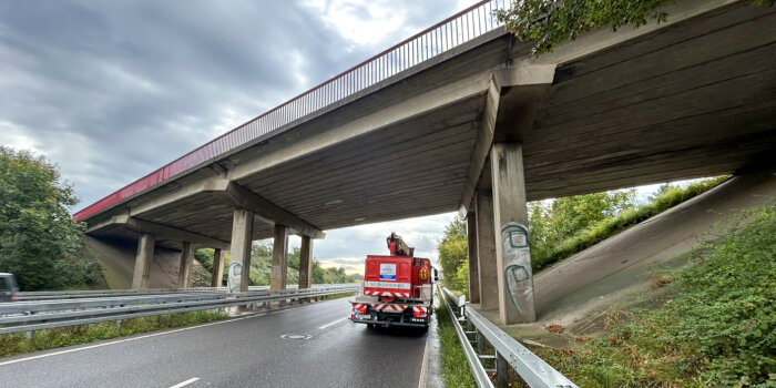 Ein Prüfungsfahrzeug steht auf einer mehrspurigen Straße unter einer Verkehrsprüfung