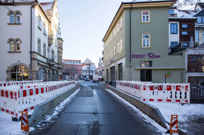 Standpunkt von der Rathausbrücke mit Blick auf die daraufstehenden Bauzäune und den Wenigemarkt, sowie die leicht eingeschneiten Häuser am Rande der Brücke.