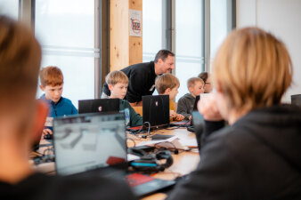 Jugendliche arbeiten an Laptops