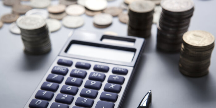 Foto: Geld zählen © Stadtverwaltung Erfurt/mizar21984/123RF Auf dem Tisch liegen Geldmünzen, ein Taschenrechner und ein Stift.