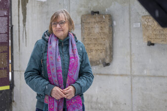 Foto: Dr. Karin Sczech im Innenhof der Alten Synagoge © Stadtverwaltung Erfurt eine Frau steht vor ausgestellten Grabsteinen