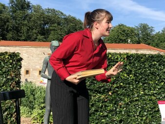 Farbfoto. Eine Frau mit einem Buch in der Hand